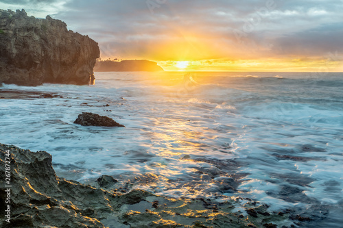 Sunrise over the ocean view from a craggy cliff, Makawehi Bluff, Kauai photo