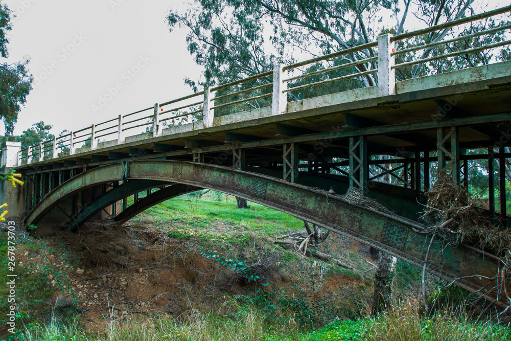 Old rusty bridge over dry riverbed Old rusty bridge over dry riverbed
