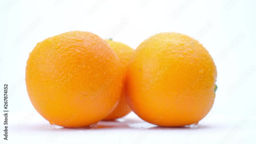 4k Rotating of orange fruit with water drop on white background.Close up macro shot. 4k Rotating of orange fruit with water drop on white background.Close up macro shot.