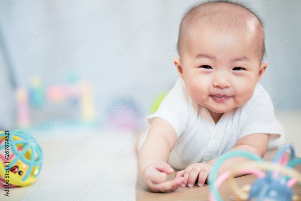 Asian baby happy in the room.Asian baby girl lying down on bed . Asian baby happy in the room.Asian baby girl lying down on bed .