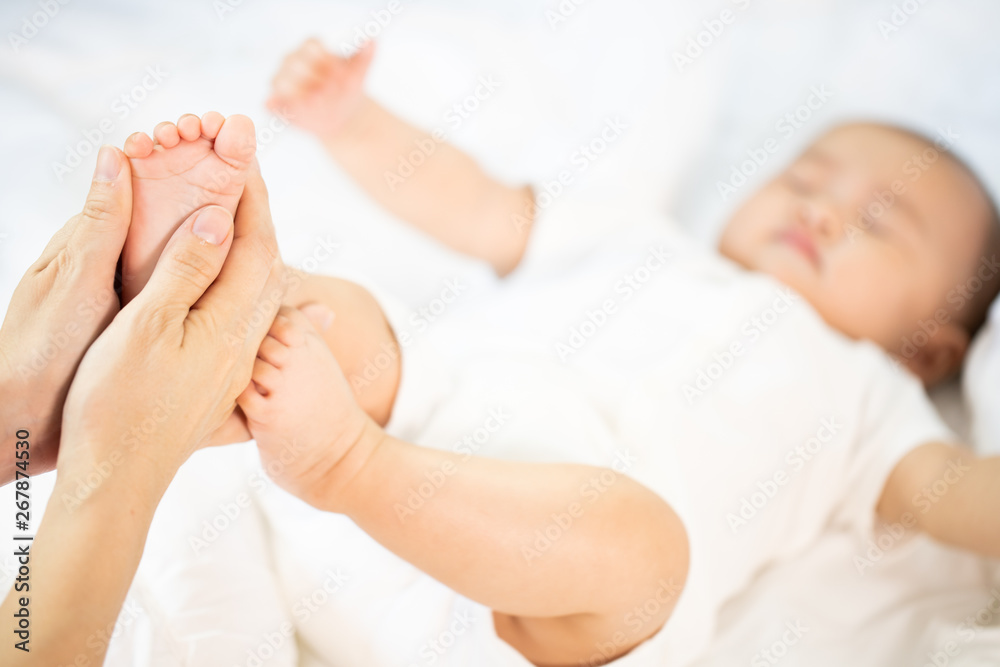 Asian baby happy in the room.Asian baby girl lying down on bed . Asian baby happy in the room.Asian baby girl lying down on bed .