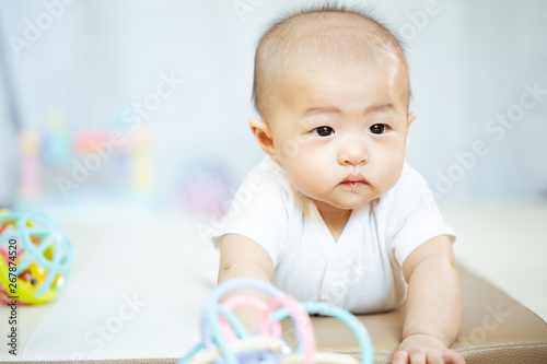 Asian baby happy in the room.Asian baby girl lying down on bed .