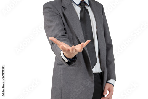 Happy young businessman looking hand in suit on white background, isolated concept