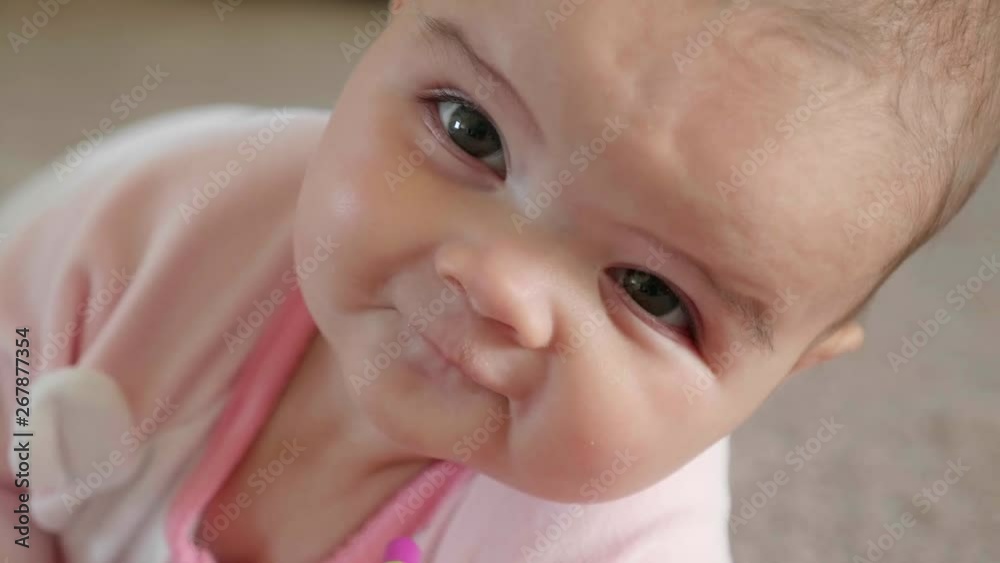 Slow motion of happy baby girl playing on the floor Slow motion of happy baby girl playing on the floor