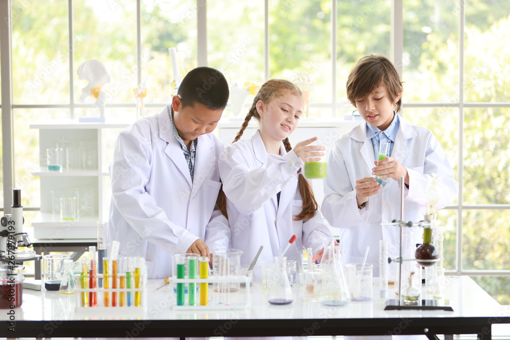 curious kid are experimenting science with attention face on colorful test tube curious kid are experimenting science with attention face on colorful test tube