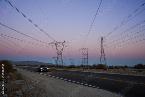 Electric Power Lines over a Desert at Sunset © Betsy