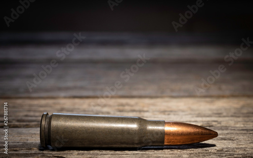 Ammunition or bullet on wood grain background. Patriotic.