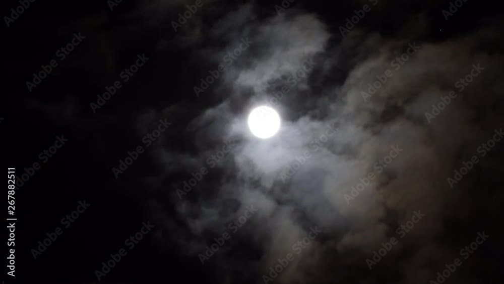 Dreams midnight moon on dark night blue sky on cloudy day. Bright white moon between volume cumulus clouds. Dreams midnight moon on dark night blue sky on cloudy day. Bright white moon between volume cumulus clouds.