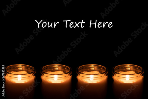 Candles burning on a black background.