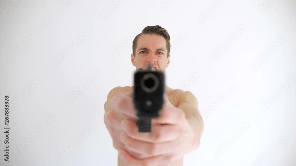 Naked man aims his gun on white background Naked man aims his gun on white background