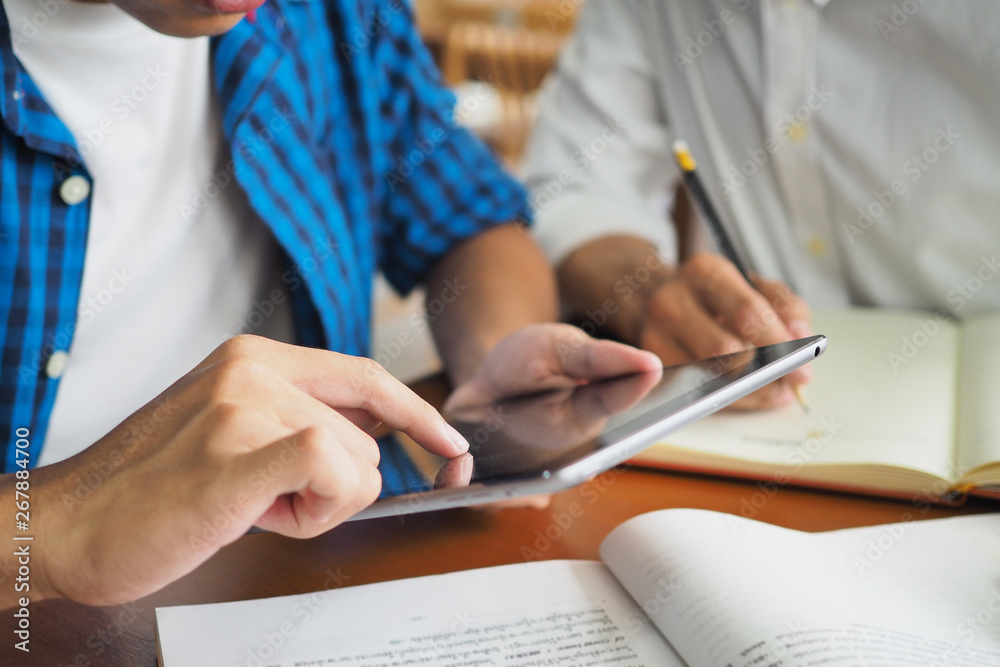 College students are studying and reading together. Have a touch tablet computer for information. College students are studying and reading together. Have a touch tablet computer for information.
