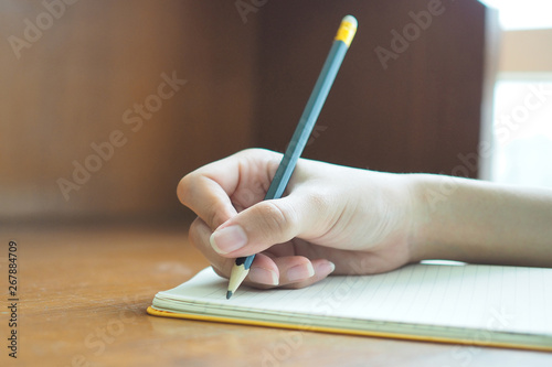 Woman's hand is writing