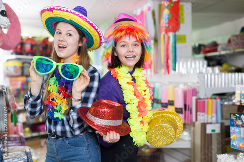 Girls joking in festive accessories shop