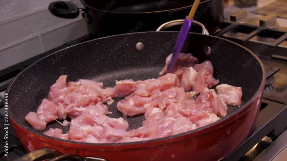 Chicken being cooked in a frying pan Chicken being cooked in a frying pan