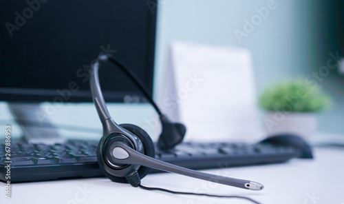 close up soft focus headphone call centre hotline at computer office help desk for background concept.	
