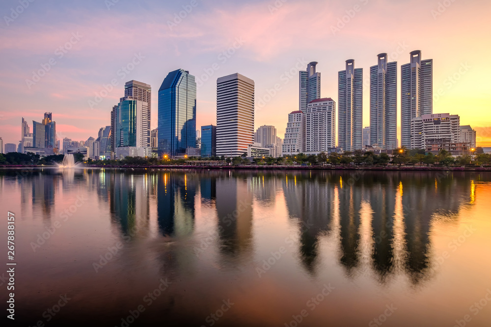 Business district cityscape from a park with sunrise time, Bangkok Thailand.