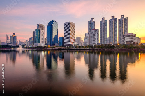 Business district cityscape from a park with sunrise time  Bangkok Thailand.