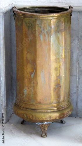 Brass umbrella stand in recessed corner