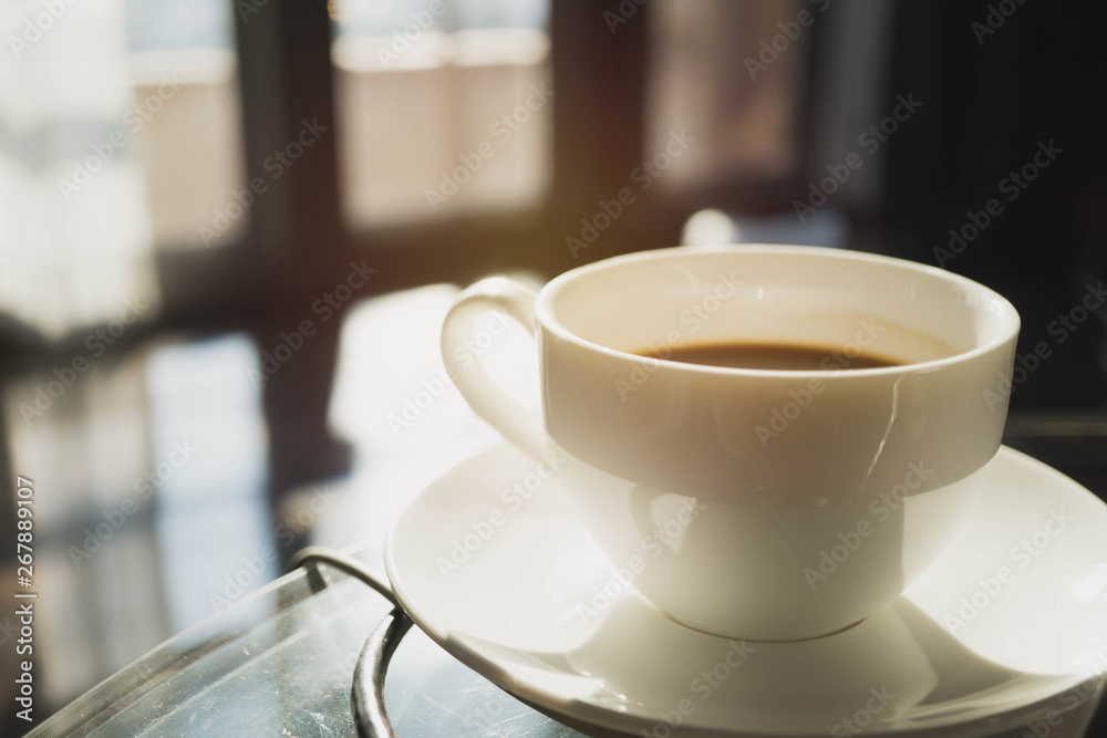 Fototapeta premium Blurry of Hand holding cap of coffee in the coffee shop cafe with blur crowded customer background.