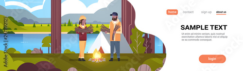 couple tourists hikers holding firewood african man woman organizing fire near camp tent hiking camping concept landscape nature river mountains background horizontal full length copy space