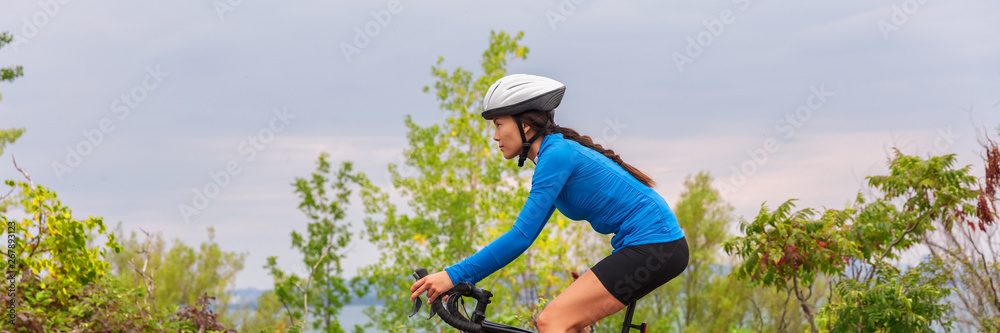 Woman biking outside riding bicycle on summer outdoor background panoramic header. Woman biking outside riding bicycle on summer outdoor background panoramic header.