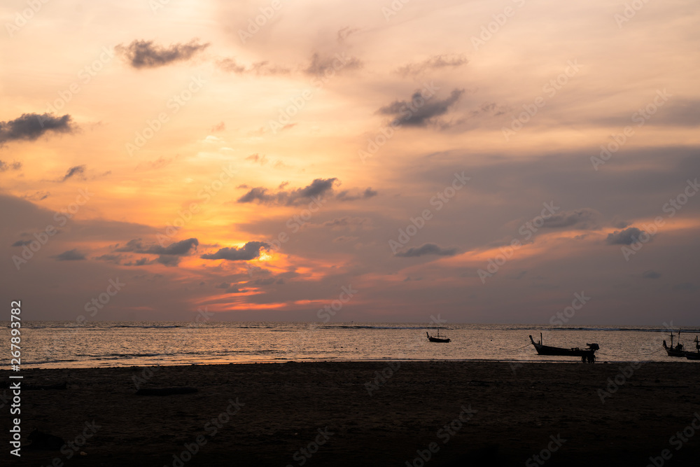 Background sky sunset,Silhouette Thai boat love travel to the beach adventure,Bright in Phuket Thailand.
