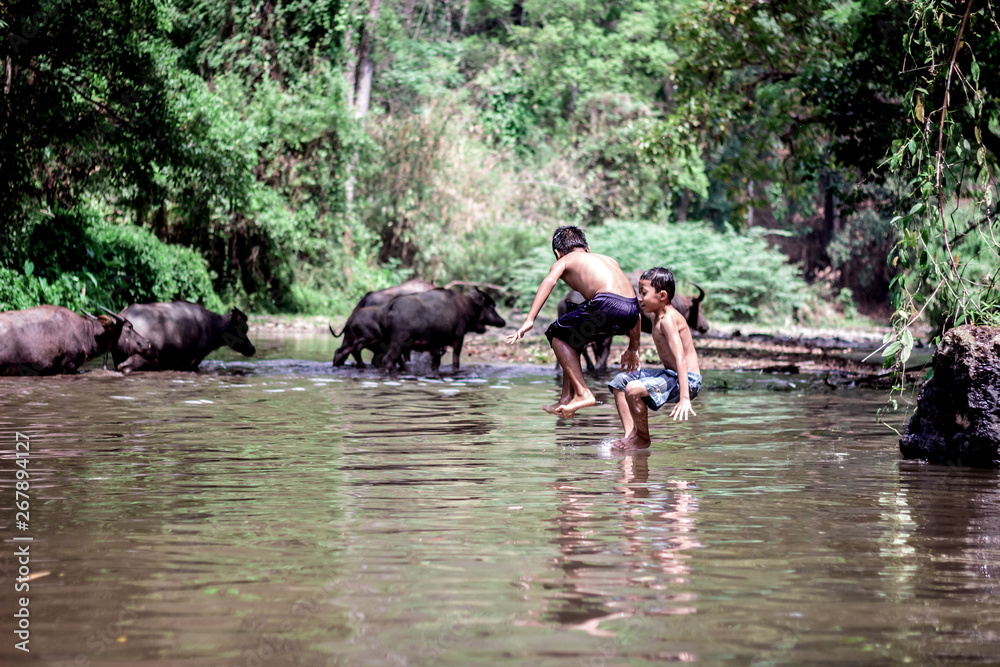 rural children playing water in the river rural children playing water in the river