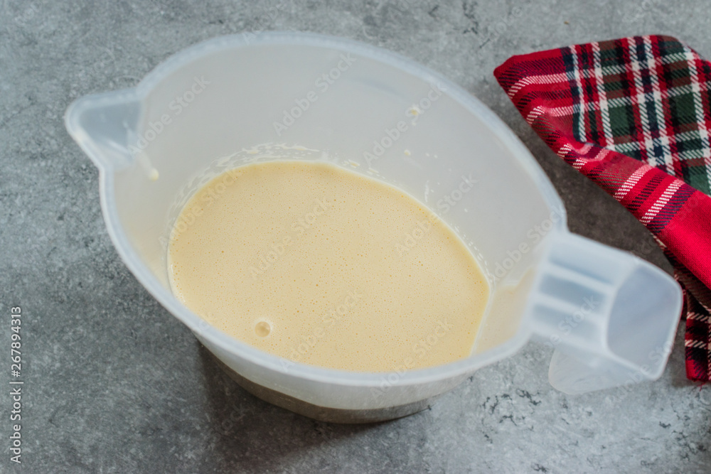 Raw Pancake Dough in Plastic Carafe Ready to Pour on Pan. Raw Pancake Dough in Plastic Carafe Ready to Pour on Pan.