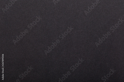 Texture of dark paper. Background for images. copyspace. space for text. sheet of gray craft paper as background. black paper