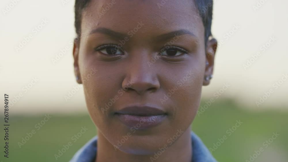 Portrait of young black female looking to camera, in slow motion Portrait of young black female looking to camera, in slow motion