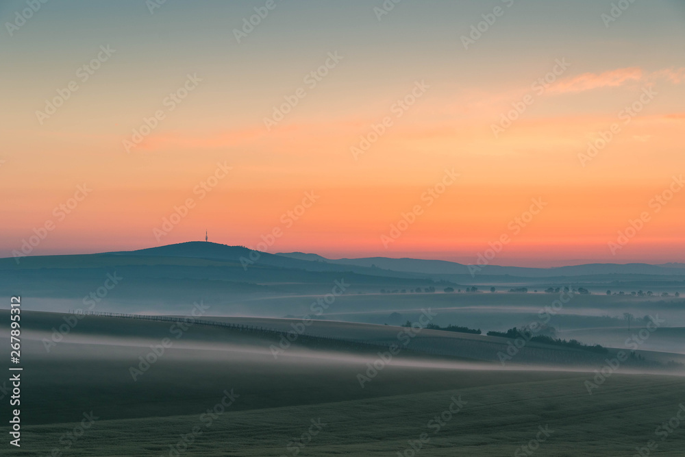 Colorful landscape during dawn in the fog just before sunrise