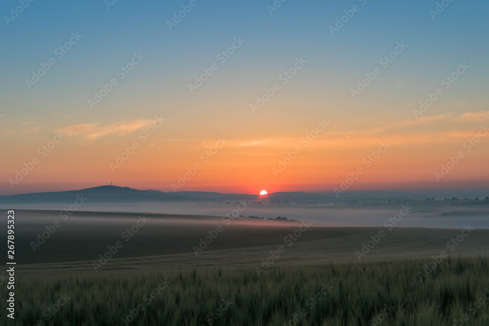 Landscape with sunrise over the hills