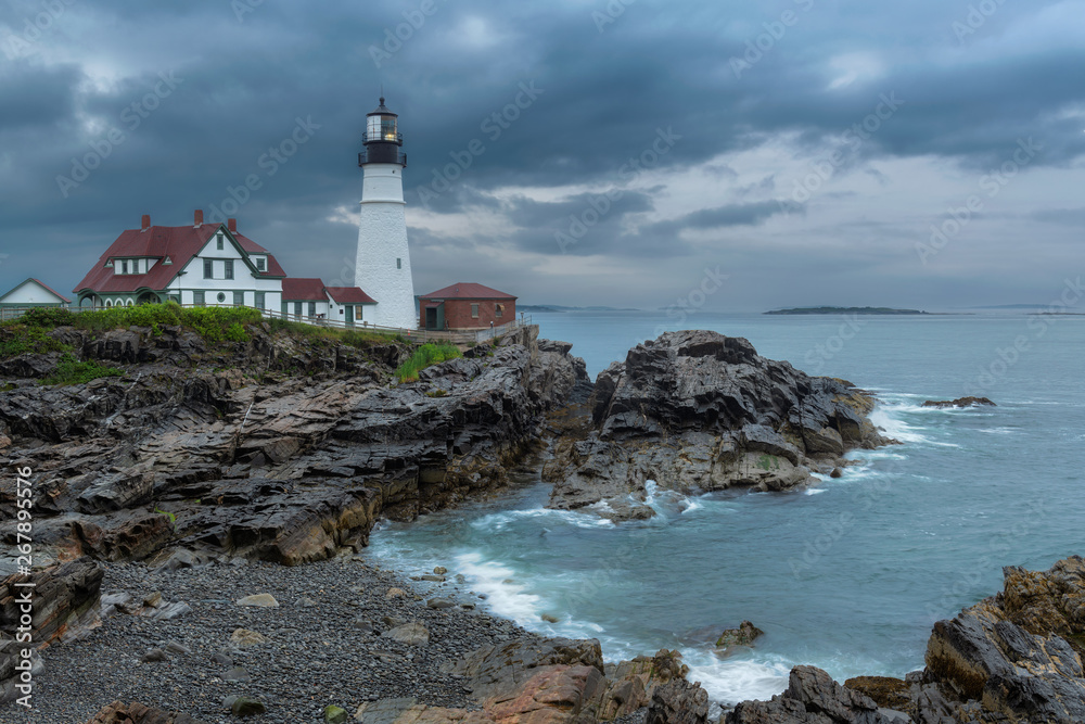 Portland Head Light at stormy dramatic clouds in Maine, New England.