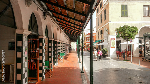 View from the street of the city market of Ciutadella de Menorca, with arches and walls decorated with checkered majolica features photo