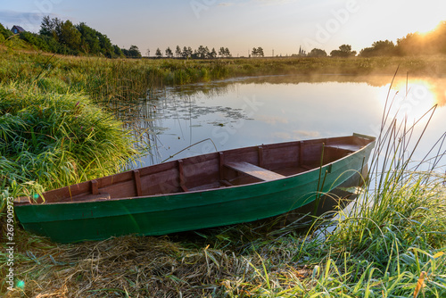 Misty morning on the river. Boat on the river. Country landscape