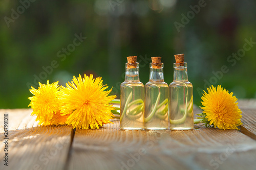 dandelion essential oil in  beautiful bottle on table