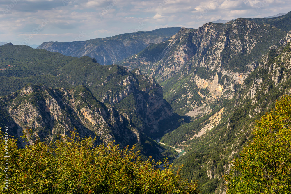 The mountains and the river Kalarrytikos (Greece)on a sunny summer day.