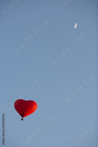 balloon and moon in the evening sky
