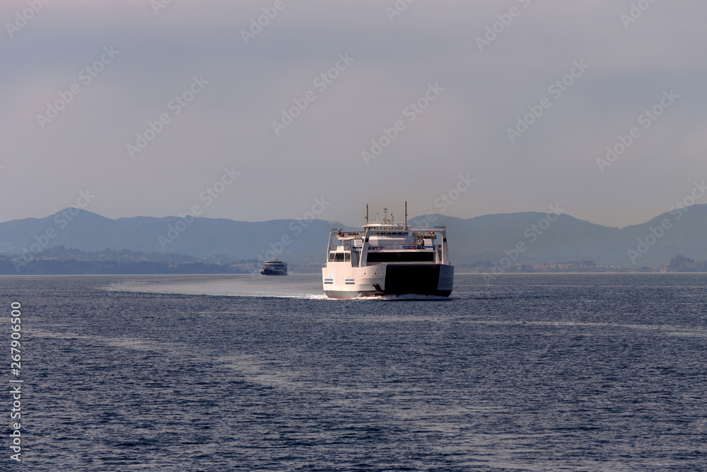 A floating ship next to the island of Corfu A floating ship next to the island of Corfu