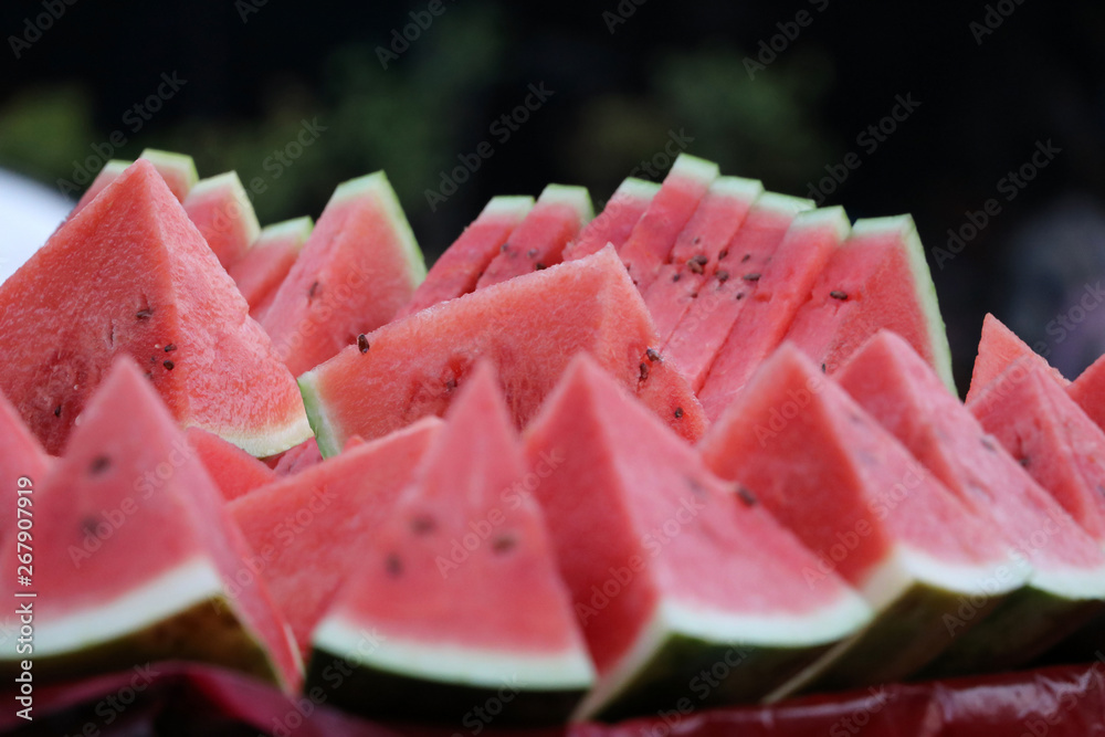 Watermelon cut into triangular pieces, put together.