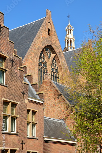 The external facade of Grote of Sint Jacobskerk with the turret of Oude Stadhuis (Old Town Hall, 16 century) in the background, The Hague, Netherlands