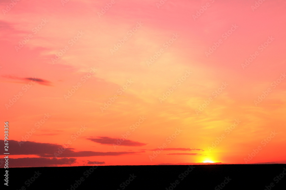 Photo of beautiful bright red color-rich tropical sunset in summer in nice slightly cloudy weather with space for writing advertising text or advertising slogan for travel agency or tour operator