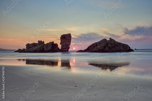 Sunset on the “playón de bayas”, on the coast of Asturias, Spain photo