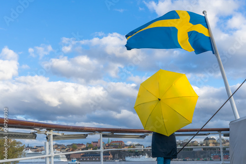 Photography Swedish flag against blue sky with white clouds