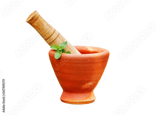 Mint herb leaf in clay mortar with pestle isolated on white background