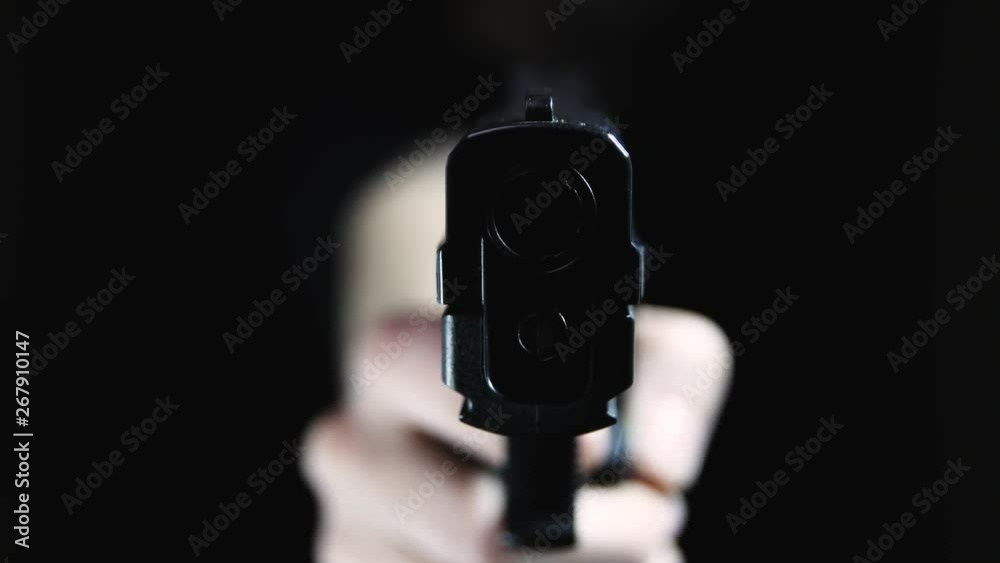 Extreme close up of the dangerous front edge of a handgun. Point-of-view shot, focus on the barrel.