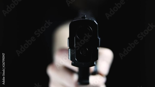 Extreme close up of the dangerous front edge of a handgun. Point-of-view shot, focus on the barrel. photo