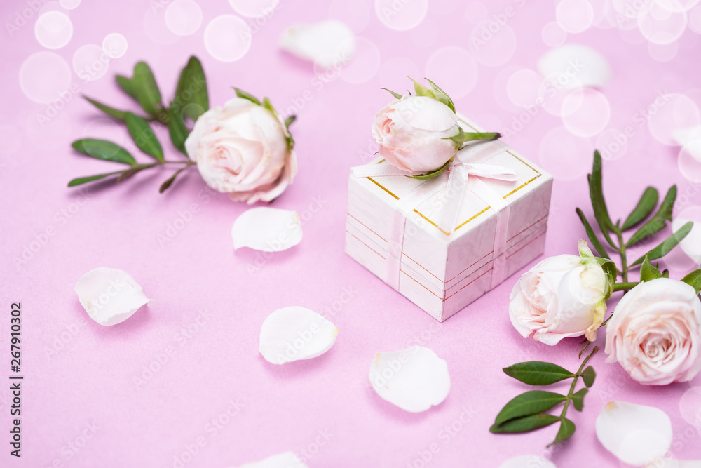 Rosebuds, petals,, gift box on a pink background. Concept for a greeting card. Weddings, Valentine's Day, Birthday Rosebuds, petals,, gift box on a pink background. Concept for a greeting card. Weddings, Valentine's Day, Birthday