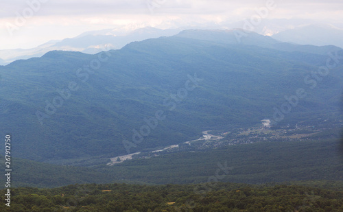 Observation deck at the top of the mountain overlooking the valley and the village Khamyshki, Lago-Naki plateau, Adygea, Russia