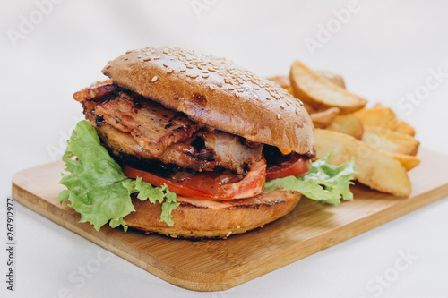 Homemade burger on rustic wooden background. Close up details